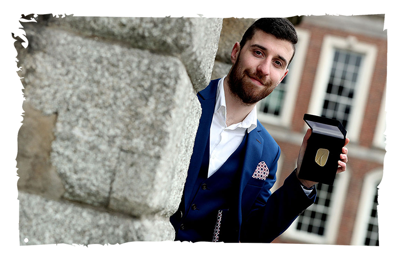 Sceitse Dylan White Duais Óir ag taispeáint a bhonn go bródúil i gCaisleán Bhaile Átha Cliath