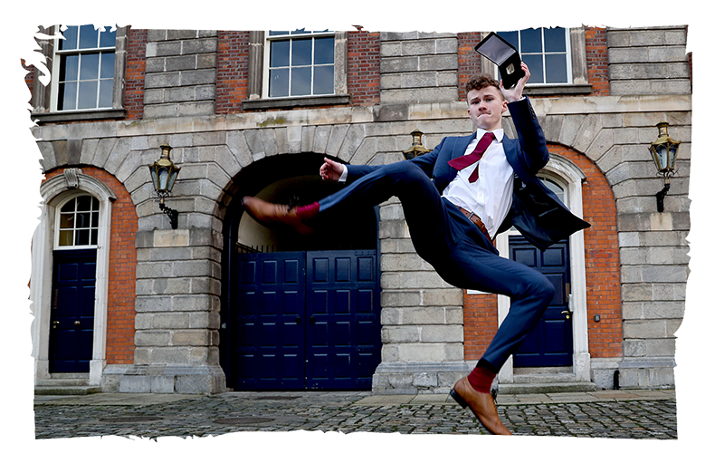 Gold Awardee celebrating with his medal at Dublin Castle by jumping in the air