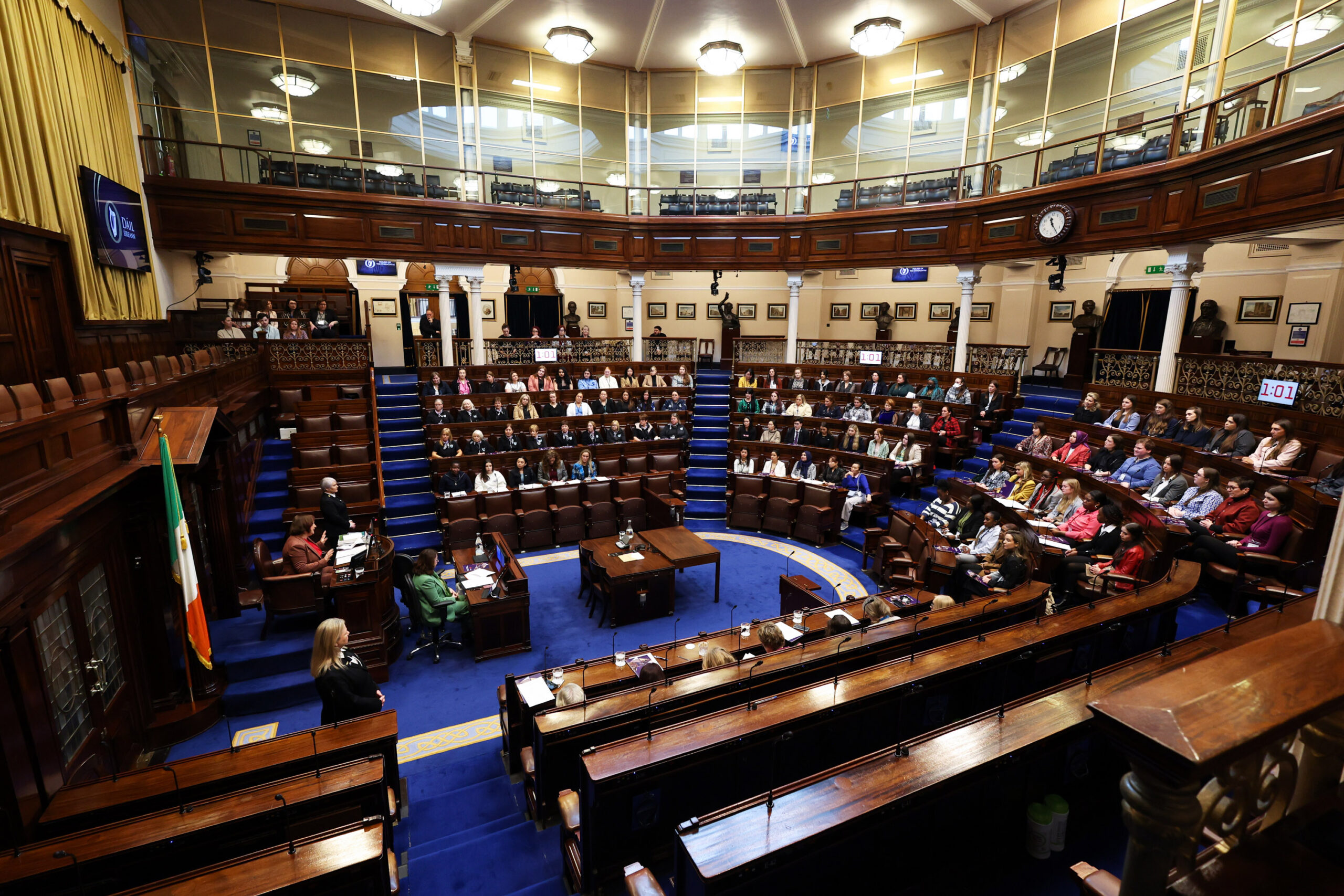A wide shot showcasing the Dáil floor with seats completely filled.