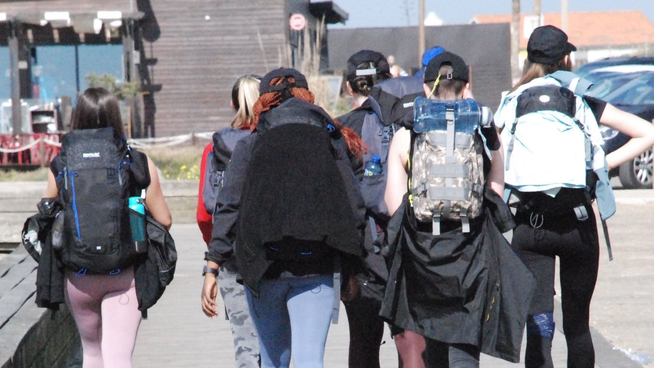 A group of students from Pobalscoil Neasáin walking together with hiking backpacks on.