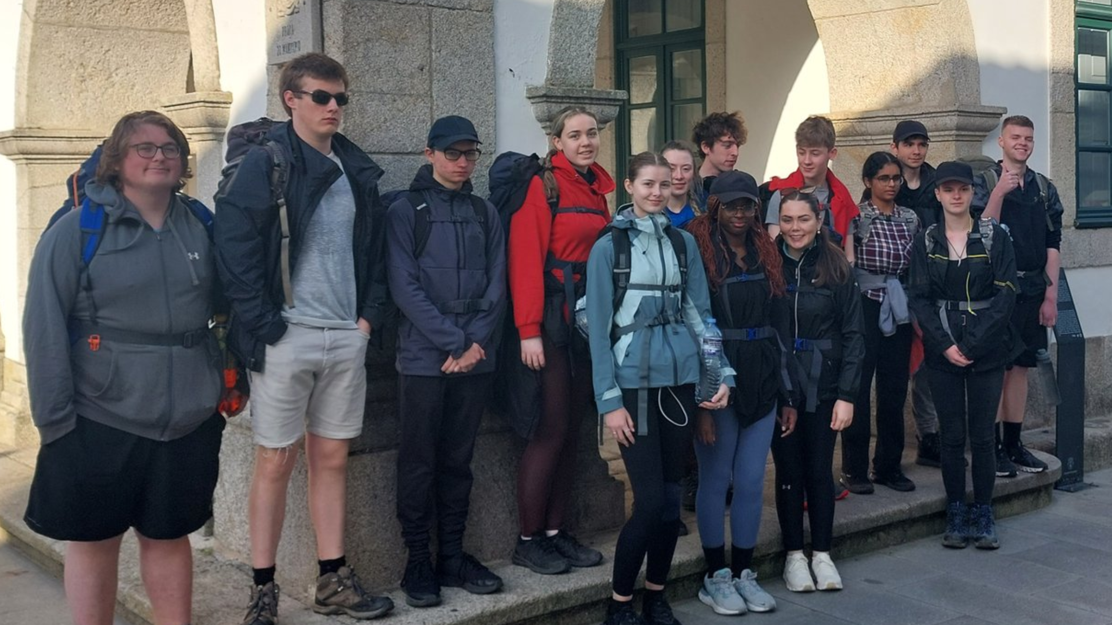 A group photo of students from Pobalscoil Neasáin. They are lined up on a street getting ready for their Hike.